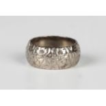 An 18ct white gold wedding ring with floral decoration, London 1961, weight 9.5g, ring size approx