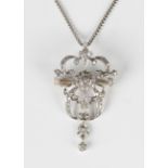 A diamond pendant brooch in a scroll pierced design, in the late 19th century taste but later,