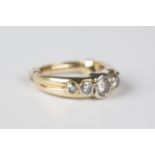 A gold and diamond five stone ring, mounted with a row of circular cut diamonds graduating in size