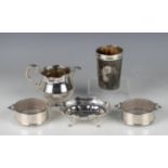 A pair of George V silver circular two-handled butter dishes, each with 'C' scroll and scallop shell