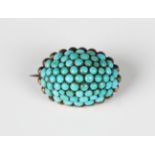 A Victorian turquoise oval brooch of domed form, pavé set with turquoises within a beaded