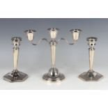 An Elizabeth II silver candlestick with matching detachable twin scroll branch forming a three-light