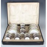 A set of six George V silver coffee can holders, each with pierced scroll decoration, Birmingham