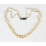 A two row necklace of graduated cultured pearls on a silver and marcasite clasp, detailed '