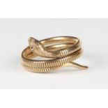 A 9ct gold and synthetic ruby bracelet, designed as a coiled snake, the head with engraved