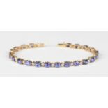 A 9ct gold, diamond and mauve gem set bracelet, mounted with small circular cut diamonds alternating