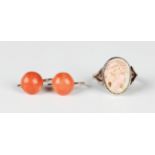 A pair of gold and coral earrings, each mounted with a coral bead, with wire hook fittings,