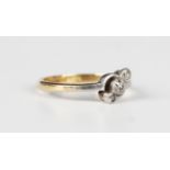 A gold, platinum and diamond three stone ring, collet set with a row of circular cut diamonds in a