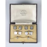 A gold, platinum, mother-of-pearl and seed pearl dress set, comprising a pair of cufflinks, four