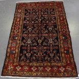 A Malayer rug, North-west Persia, early 20th century, the blue field with a floral lattice, within a