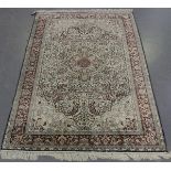 A Kashmir part silk rug, late 20th century, the charcoal field with a flowerhead medallion, within a