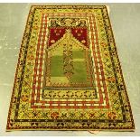 A 19th century needlework tapestry copy of a Turkish prayer rug, worked in overall coloured wools,