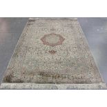 A fine Kashmir part silk carpet, late 20th century, the ivory field with a lobed medallion,