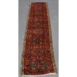 A Heriz runner, North-west Persia, early/mid-20th century, the red field with a single column of