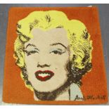 A machine made rug, depicting a portrait of Marilyn Monroe, after Andy Warhol, 85cm x 80cm.Buyer’s