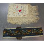 An early 20th century ivory silk shawl, embroidered with polychrome flowers and tendrils, 110cm x