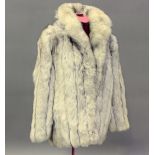 A mid/late 20th century Arctic fox fur half-length lady's coat by Saga, length 70cm.Buyer’s