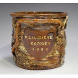 A Sussex pottery jar, dated 1906, of cylindrical form applied with a brown glazed shield