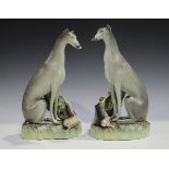 A pair of Parr factory Staffordshire pottery whippets, 1860s, each seated grey animal on a