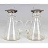 A pair of George V silver mounted conical cut glass whisky tots, each with silver collar and