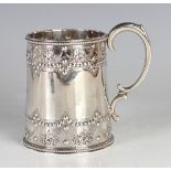 A Victorian silver christening tankard of tapered cylindrical form, decorated in relief with