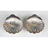 A pair of late Victorian silver butter shells, each raised on ball feet, Sheffield 1900 by James