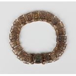 A mid-19th century gold bracelet, the links in a pierced rectangular and circular link design, on