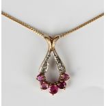 A 9ct gold, ruby and diamond drop shaped pendant, claw set with five graduated circular cut rubies