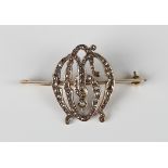 A gold, silver gilt and diamond brooch, designed as a monogram, mounted with rose cut diamonds,