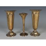 A pair of George V silver specimen vases, each of tapering cylindrical fluted form with cast rims,