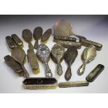 A collection of various silver backed dressing table items, including a hand mirror, hairbrushes and