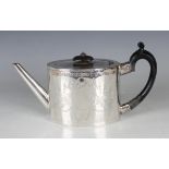 A George III silver teapot of oval form, the body engraved with floral and foliate garlands