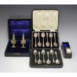 A small group of silver items, comprising a pair of baluster pepper casters, each with a reeded