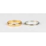 A 22ct gold decorated wedding ring, London 1990, weight 3g, ring size approx N, and a platinum