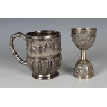 A late 19th/early 20th century Indian silver tankard, the body chased with figures in village