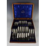 A set of twelve late Victorian silver and mother-of-pearl handled dessert knives and forks,