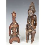 A Senufo carved wooden maternity figure of a seated mother and child, height 41cm, together with