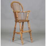A 20th century Victorian style ash and elm Windsor high chair, height 90cm, width 39cm.Buyer’s