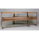 A near pair of late 19th century French oak benches with scrolling bar backs, height 76cm, width