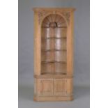 A 19th century Neoclassical Revival pine barrel-back corner display cupboard, the frieze with