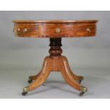 A late George III mahogany drum topped library table, the revolving top inset with tooled leather