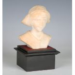 An early 20th century Continental carved alabaster bust of a young girl, initialled 'ALH', raised on