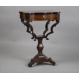 A mid-19th century rosewood and inlaid work table, the hinged lid with an inlaid and penwork scene