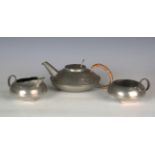 A Liberty & Co 'Tudric' pewter three-piece tea set, designed by Archibald Knox, model number '0231',