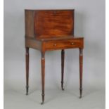 A late George III mahogany writing table, the gallery back with a fall-flap compartment enclosing