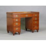 A late Victorian teak campaign twin pedestal desk, the galleried top above drawers with recessed