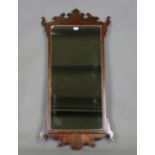 A 19th century George III style walnut fretwork wall mirror, height 117cm, width 57cm.Buyer’s