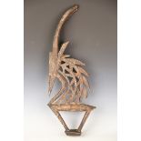 A Bambara Chiwara headdress of antelope form, height 78cm, together with an African carved figural