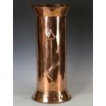 A 20th century Arts and Crafts copper stick stand, the cylindrical body embossed with three stylized