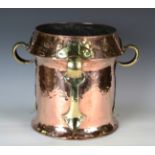 An early 20th century Arts and Crafts copper and brass mounted jardinière with overall hammered